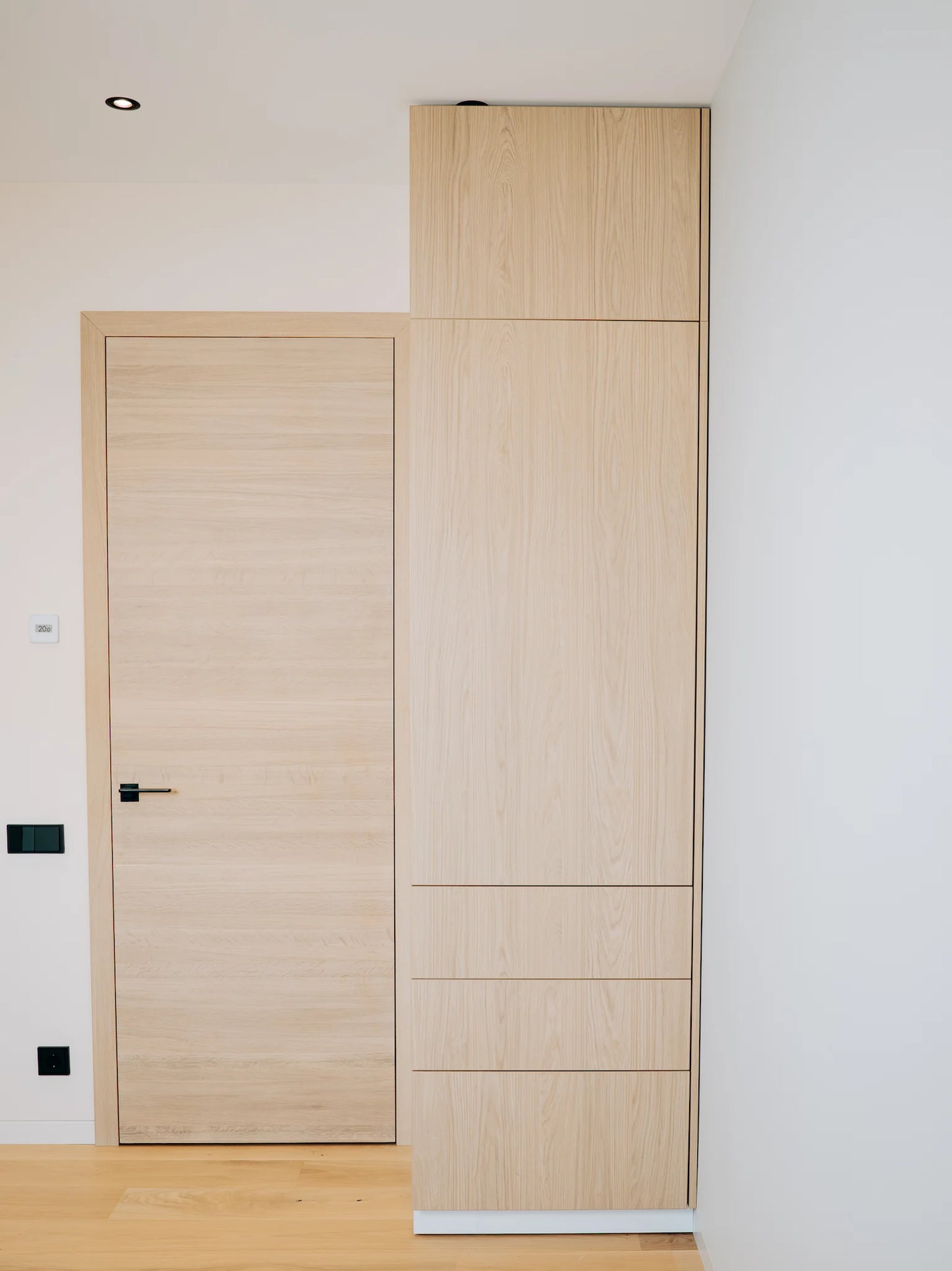 Wooden door and wardrobe against a white wall