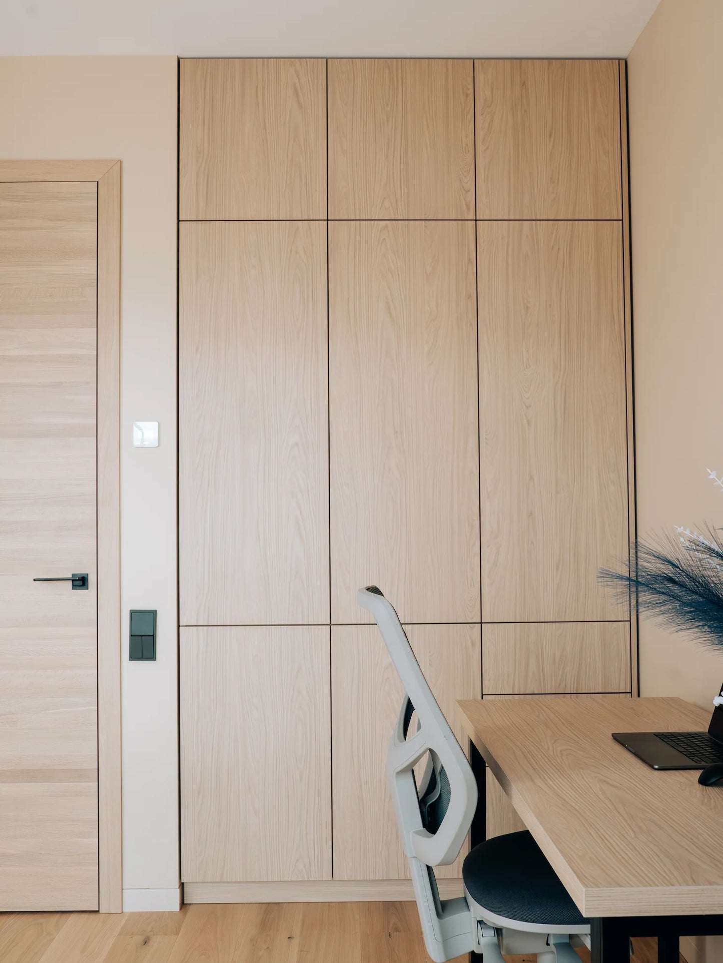 Wooden office setup with a desk, chair, and cabinets.