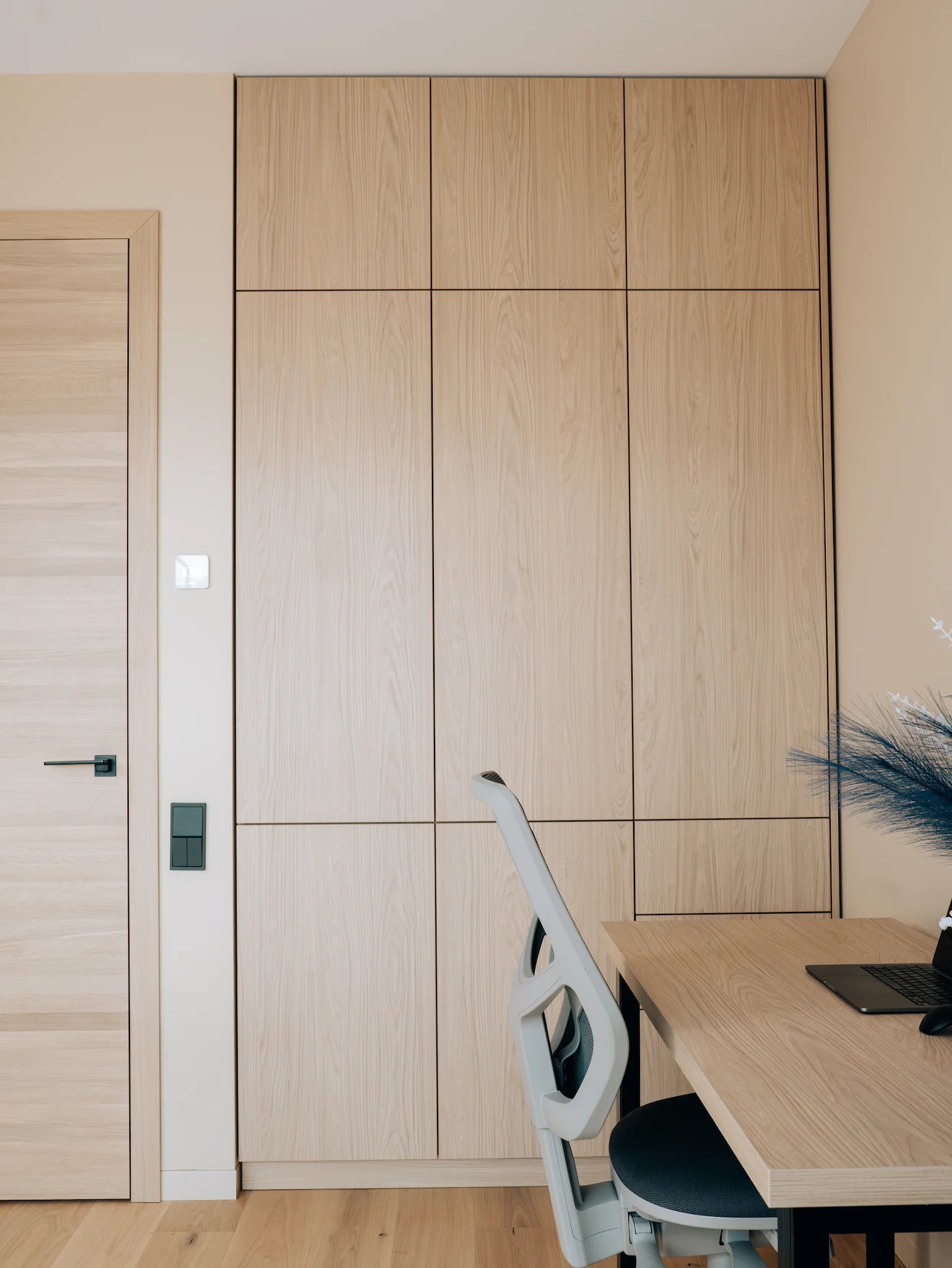 Wooden office setup with a desk, chair, and cabinets.