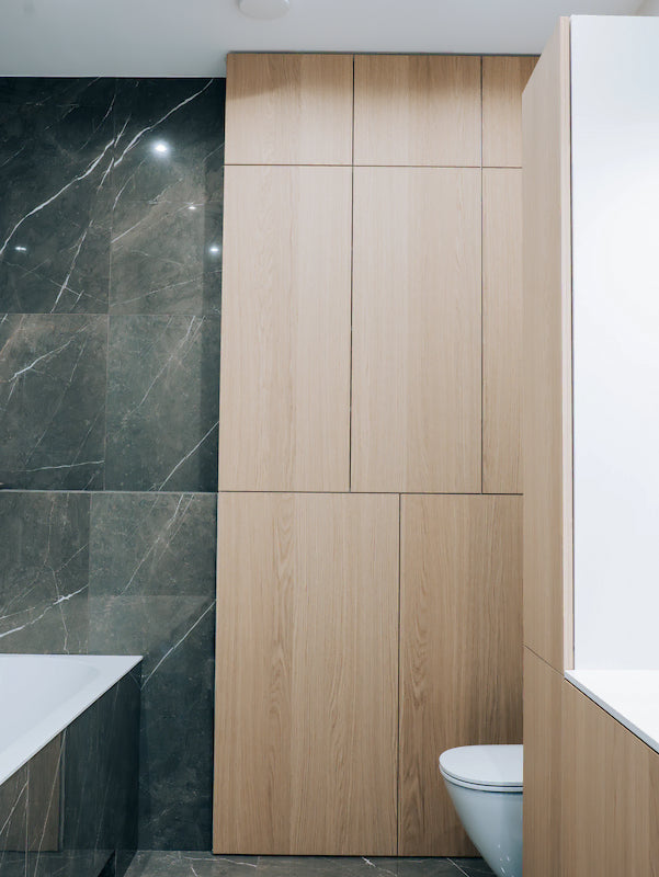 Bathroom with wooden paneling and marble wall