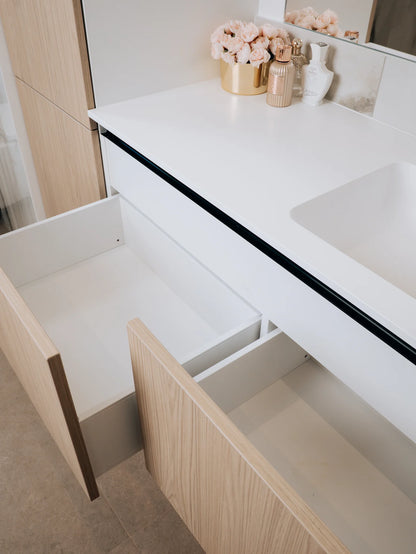 Bathroom vanity with open drawer and countertop