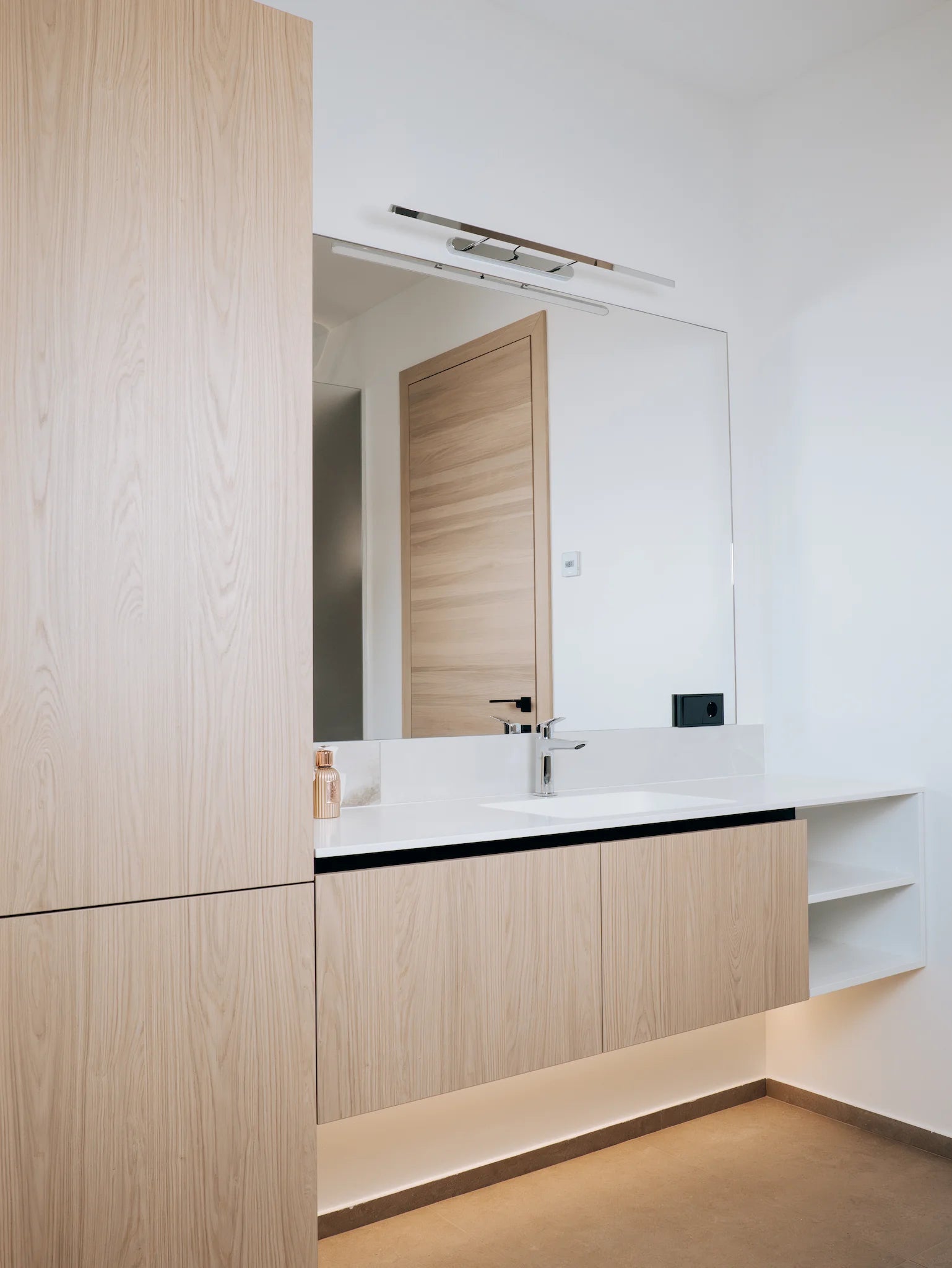 Modern bathroom with wooden cabinets and a mirror