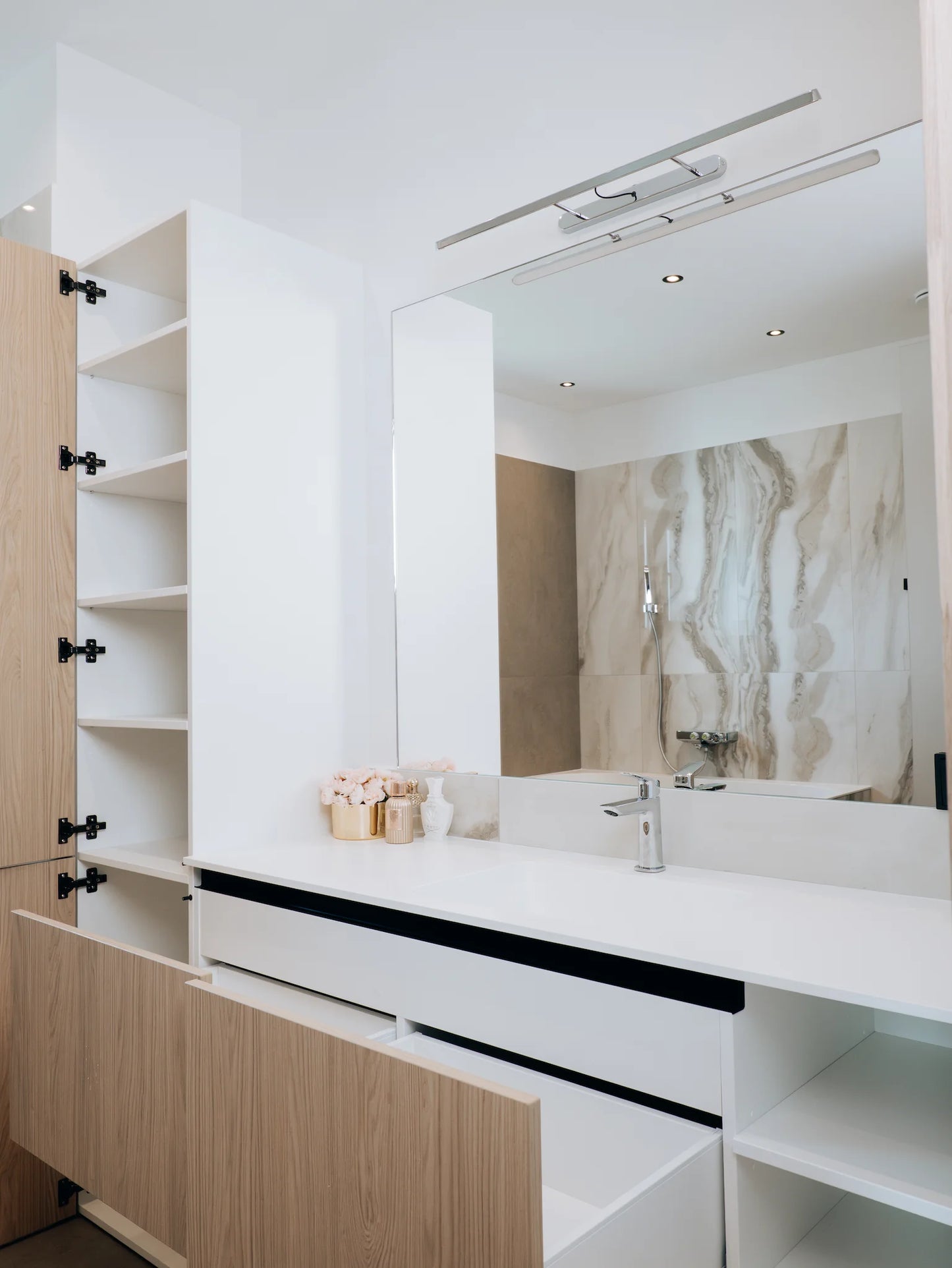Modern bathroom vanity with large mirror and light fixture